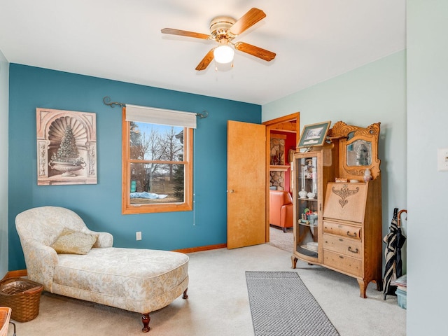 sitting room with carpet floors, ceiling fan, and baseboards