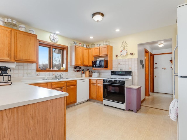 kitchen with white appliances, a sink, light countertops, backsplash, and light floors