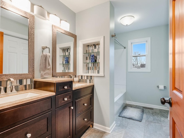 bathroom featuring shower / tub combination, a sink, visible vents, baseboards, and double vanity