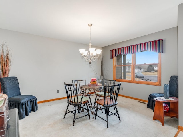 dining room featuring a chandelier, carpet flooring, visible vents, and baseboards