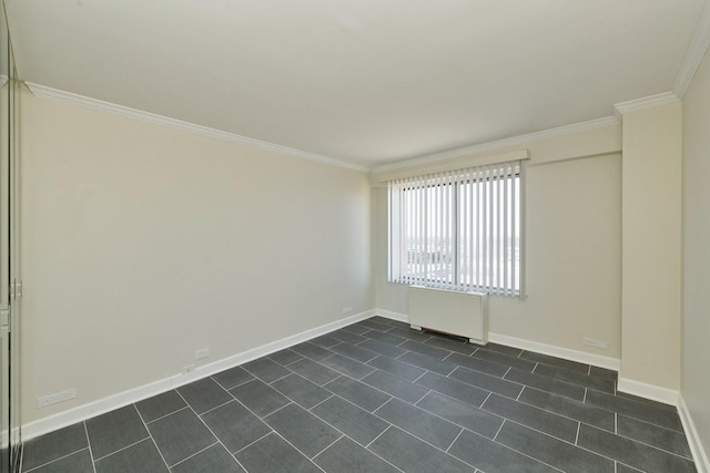 spare room featuring ornamental molding and baseboards