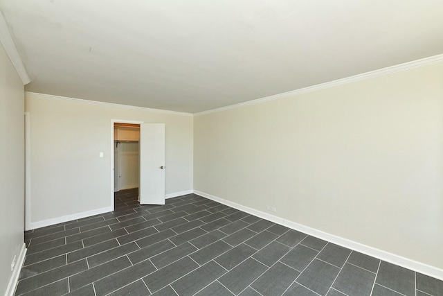 empty room with crown molding and baseboards