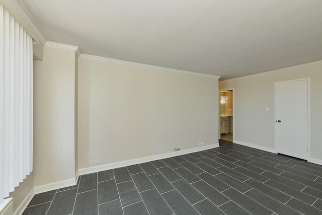 empty room featuring ornamental molding and baseboards