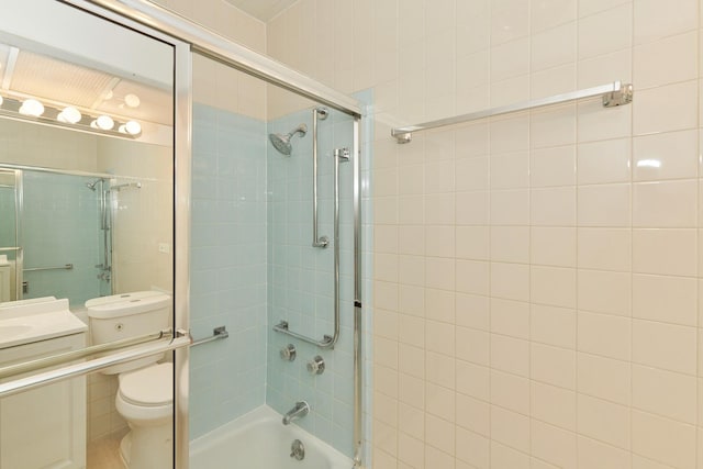 bathroom featuring shower / bath combination with glass door, vanity, and toilet