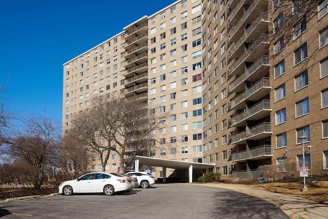 view of building exterior with uncovered parking