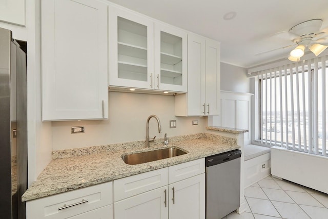 kitchen featuring appliances with stainless steel finishes, a sink, and white cabinets