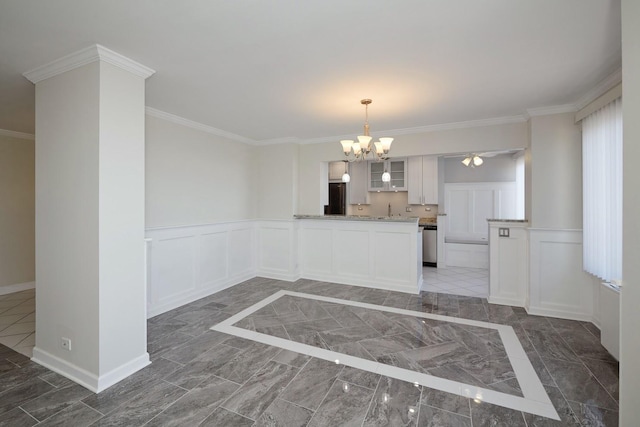 kitchen with ornamental molding, dishwasher, baseboards, and an inviting chandelier