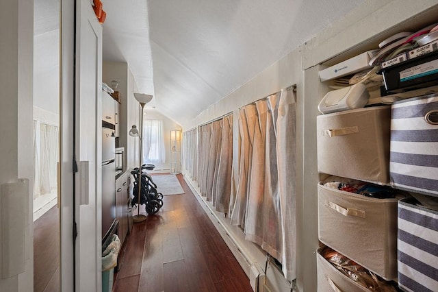 hall featuring dark wood-type flooring and vaulted ceiling