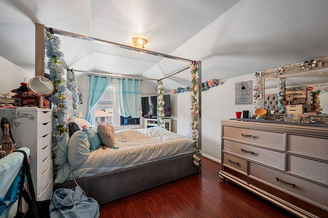 bedroom featuring lofted ceiling and wood finished floors