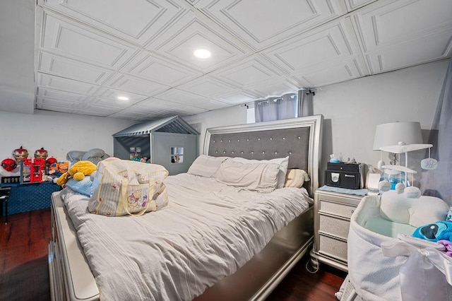 bedroom featuring dark wood-style floors, an ornate ceiling, and recessed lighting