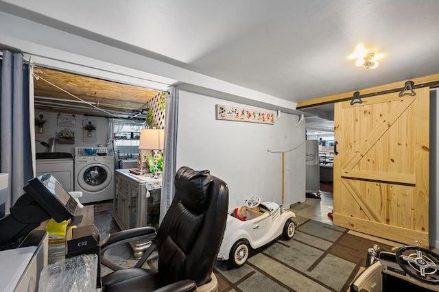 interior space with a barn door and washer and clothes dryer