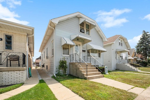 view of front of house with a residential view and a front yard