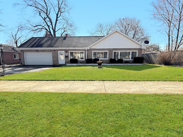 ranch-style home featuring brick siding, fence, a garage, driveway, and a front lawn