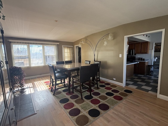 dining room featuring wood finished floors and baseboards