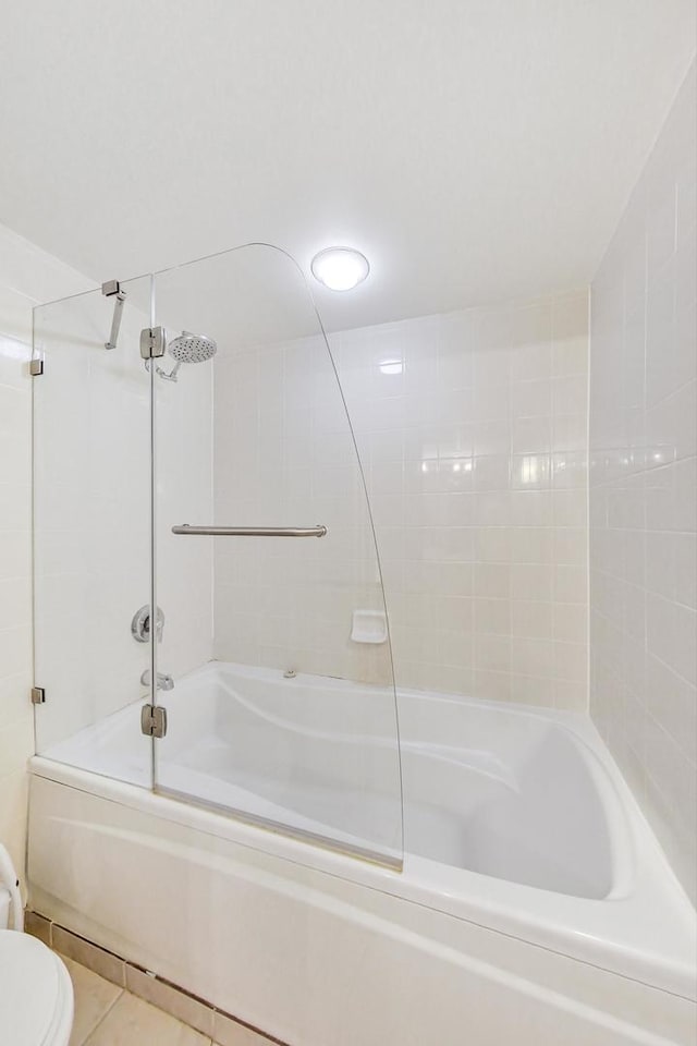 bathroom with shower / bathtub combination, toilet, and tile patterned floors