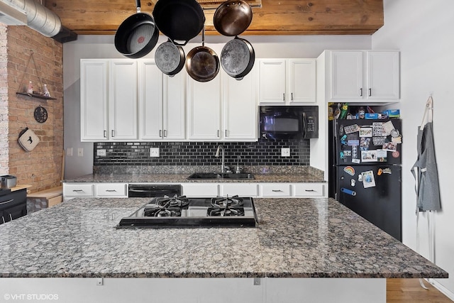 kitchen with black appliances, decorative backsplash, white cabinets, and a sink