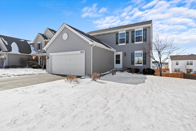 view of front of property with an attached garage and fence