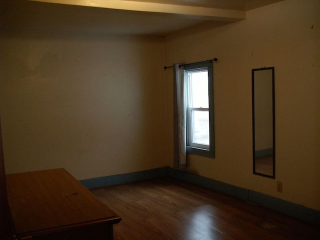 unfurnished room with wood finished floors and baseboards