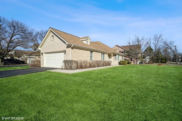 view of property exterior with driveway, a garage, roof with shingles, a yard, and brick siding