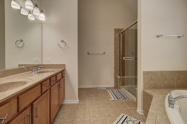 full bath with tile patterned floors, a stall shower, double vanity, and a sink