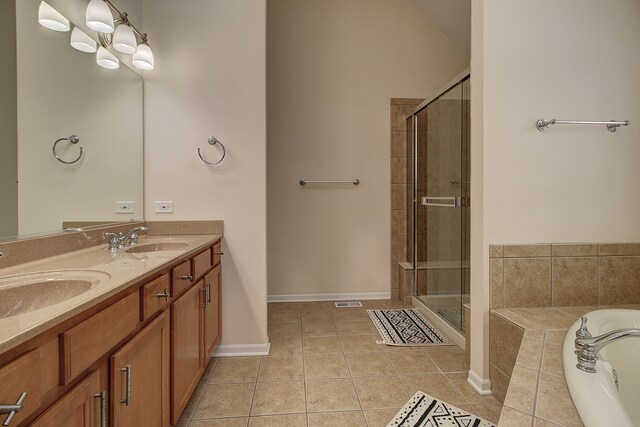 26403 W Red Apple Rd, Plainfield, IL 60585 - full bathroom featuring tile patterned floors, a stall shower, double vanity, a relaxing tiled tub, and baseboards