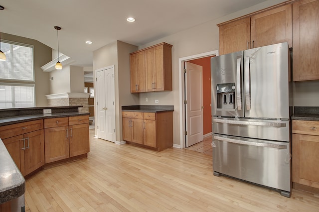 kitchen featuring stainless steel fridge with ice dispenser, decorative light fixtures, recessed lighting, light wood-style flooring, and brown cabinets