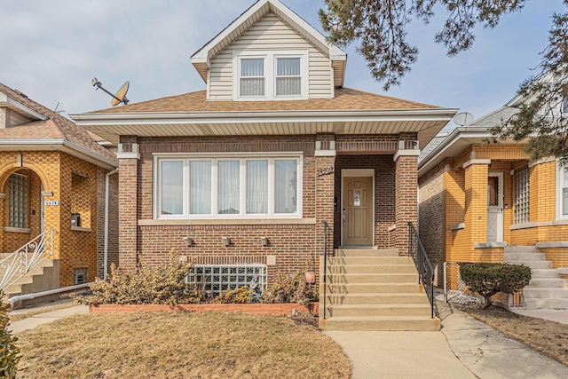 view of front of house featuring brick siding and a shingled roof