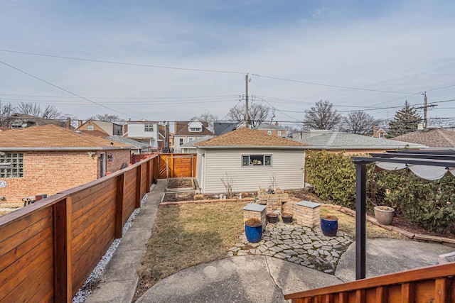 view of yard featuring a patio, a fenced backyard, and a garden