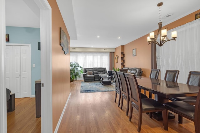 dining space featuring recessed lighting, visible vents, baseboards, light wood finished floors, and an inviting chandelier