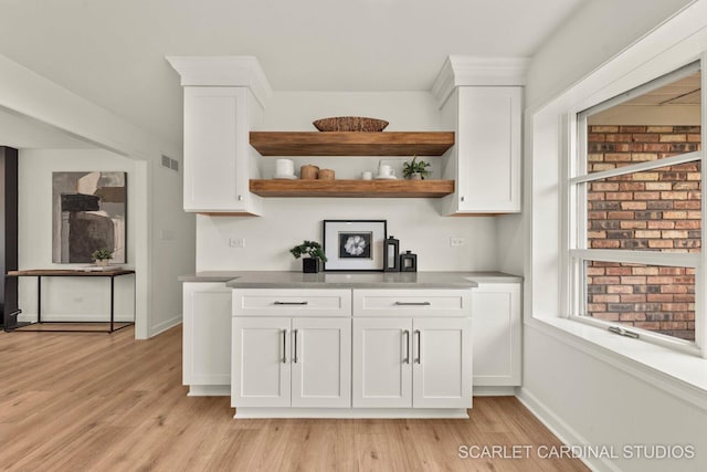 kitchen featuring white cabinets, plenty of natural light, open shelves, and light wood-type flooring