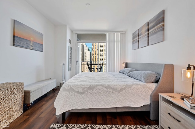 bedroom with access to outside and dark wood-style flooring