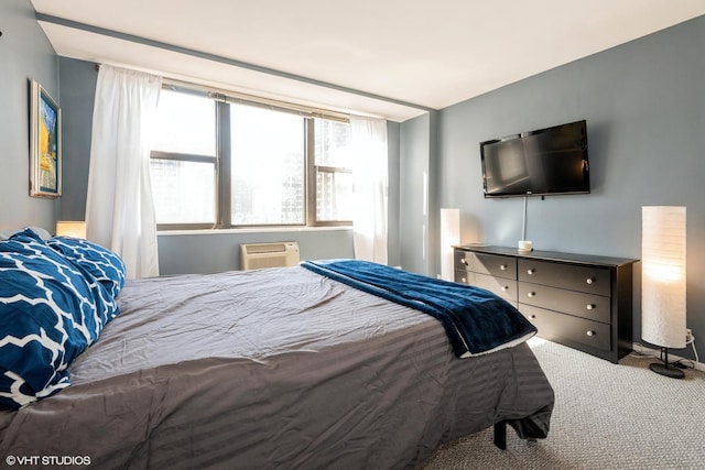 bedroom with carpet floors and a wall unit AC