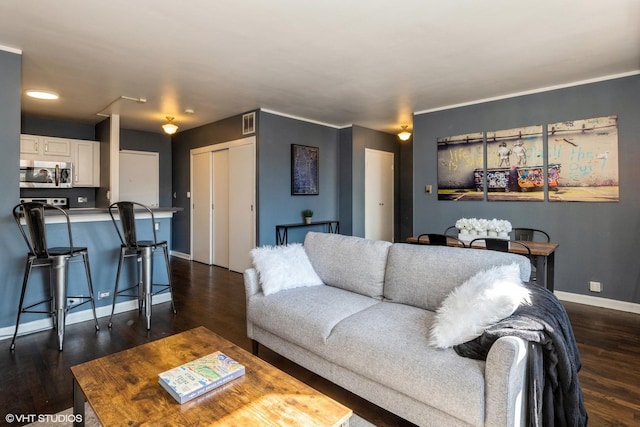 living room with visible vents, dark wood finished floors, and baseboards