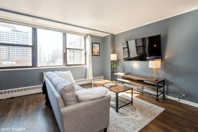 living area with a baseboard radiator, baseboards, and wood finished floors