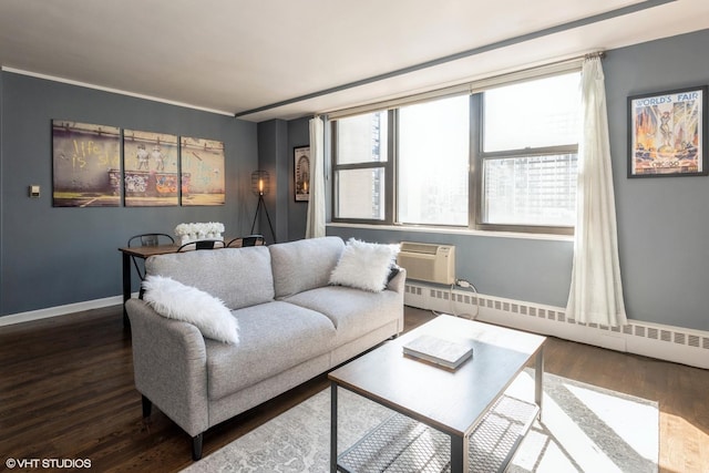 living room with a baseboard heating unit, a wall mounted AC, wood finished floors, and baseboards