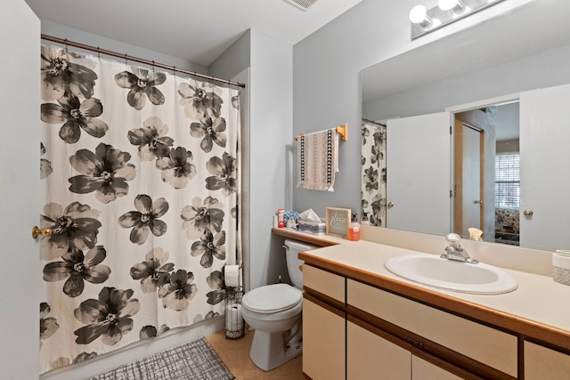 bathroom featuring toilet, a shower with curtain, tile patterned flooring, and vanity