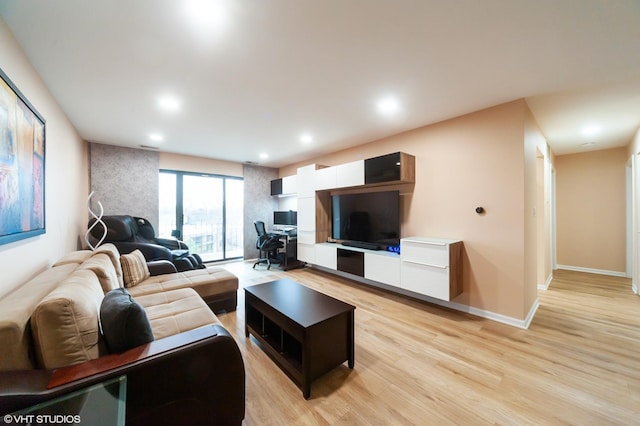 living room with light wood finished floors, recessed lighting, and baseboards