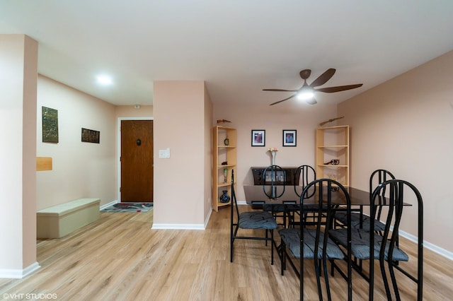 dining room with a ceiling fan, baseboards, and wood finished floors