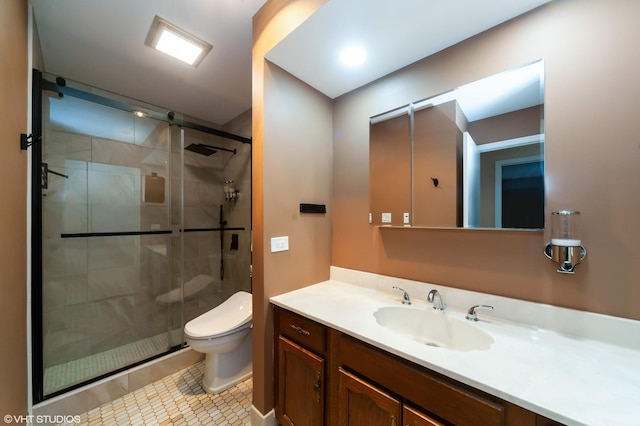 bathroom with a stall shower, tile patterned flooring, vanity, and toilet