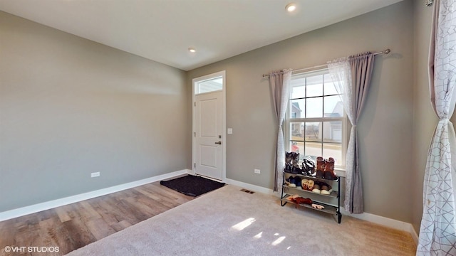 foyer entrance with visible vents, baseboards, and recessed lighting