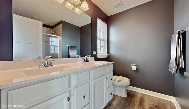 bathroom featuring double vanity, a sink, visible vents, and a shower stall