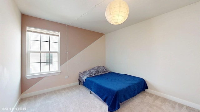 carpeted bedroom featuring baseboards