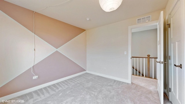 unfurnished room featuring carpet floors, visible vents, and baseboards