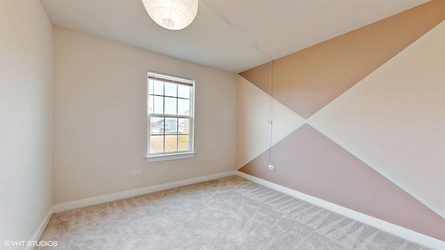 carpeted empty room with baseboards