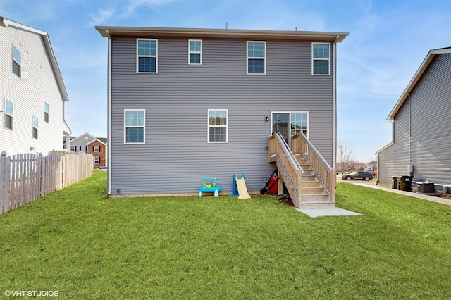 back of house with stairs, fence, cooling unit, and a yard