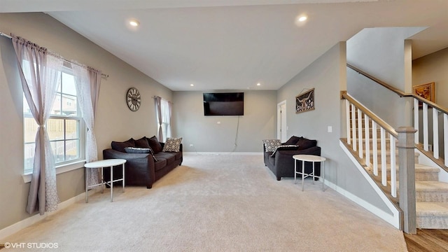 living area with recessed lighting, stairway, and baseboards