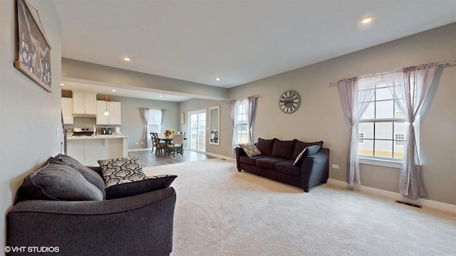 living area with baseboards, carpet, and recessed lighting