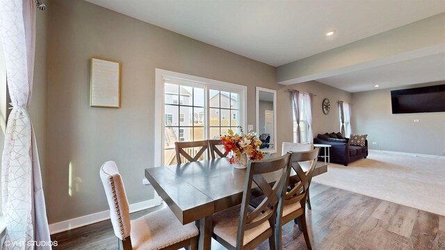 dining area with baseboards, wood finished floors, and recessed lighting