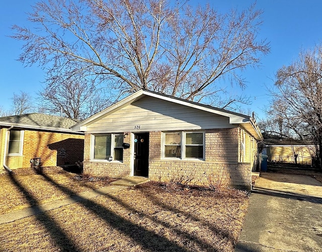 bungalow-style home with brick siding