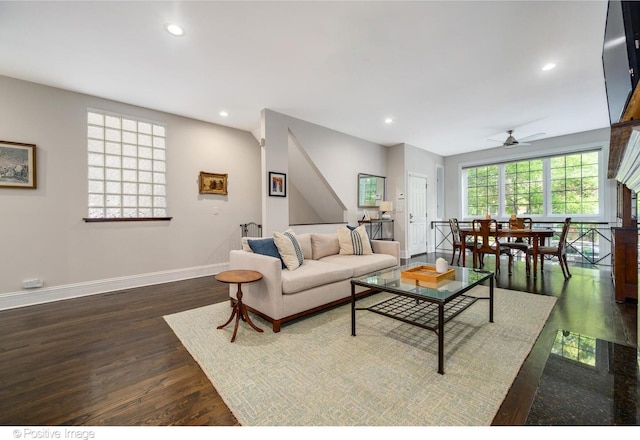 living area with baseboards, dark wood finished floors, and recessed lighting